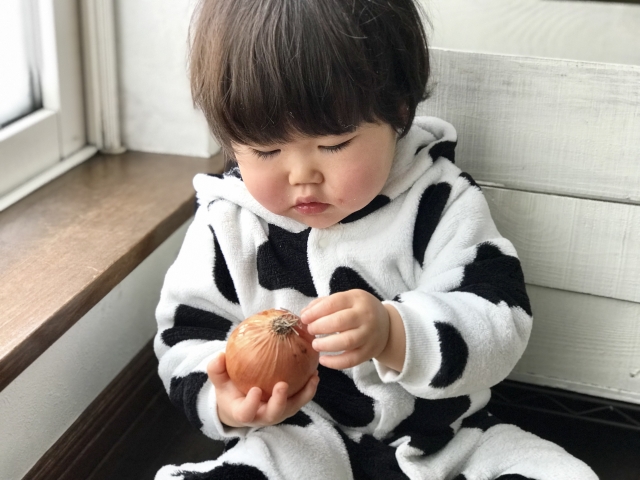 玉ねぎの皮をむく子ども
